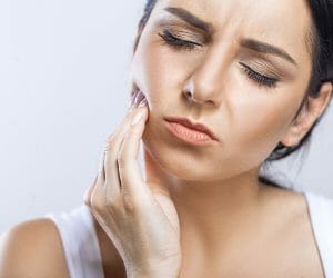 Woman feeling tooth pain