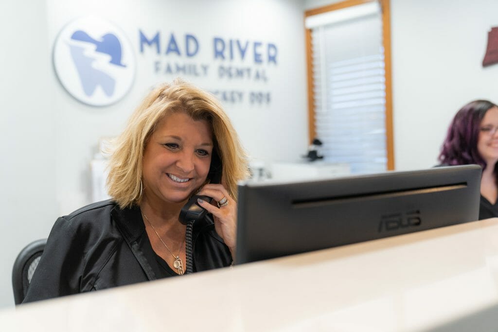 Front desk team speaking with patient on the phone