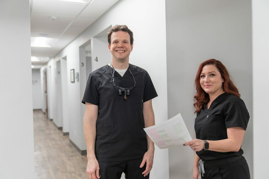 Dr. Hickey and team member smiling in hallway