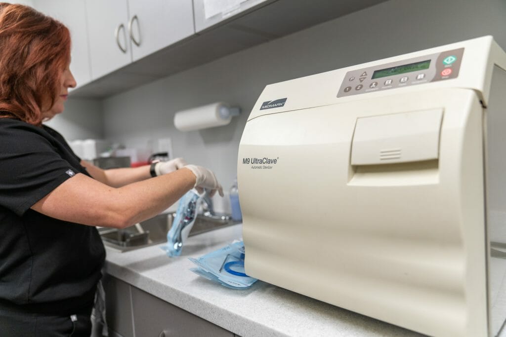 Mad River Family Dental team member sterilizing dental equipment